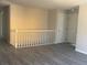 Hallway with fresh paint, wood floors, and access to bedrooms and bathrooms throughout the home at 8491 W Star Cir, Littleton, CO 80128