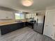Updated kitchen featuring stainless steel appliances, light countertops, dark cabinets, and a window at 8491 W Star Cir, Littleton, CO 80128