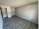 Neutral living room with updated gray plank flooring and modern gray walls at 8491 W Star Cir, Littleton, CO 80128