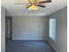 Bright living room featuring wood floors, fresh paint, and a modern ceiling fan with light fixture at 8491 W Star Cir, Littleton, CO 80128