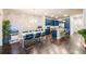 Open-concept dining room and kitchen with modern lighting and blue cabinets at 15345 W 64Th Ln # 201, Arvada, CO 80007