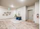 Bright condo hallway with modern decor, a console table, and blue ottomans creates a welcoming atmosphere at 15345 W 64Th Ln # 201, Arvada, CO 80007