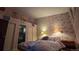 Cozy bedroom with floral wallpaper, comfortable bed, and soft lighting at 1470 S Quebec Way # 245, Denver, CO 80231
