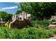 The Hunt Club community sign surrounded by trees, bushes and beautiful landscaping at 1470 S Quebec Way # 245, Denver, CO 80231