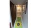 Hallway with unique rug, wood-look closet doors, and neutral paint at 1470 S Quebec Way # 245, Denver, CO 80231