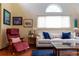 Inviting living room with comfortable seating, a large window, and stylish decor at 1470 S Quebec Way # 245, Denver, CO 80231