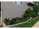 Side view of home featuring a lush garden, and well-maintained landscaping at 1470 S Quebec Way # 245, Denver, CO 80231