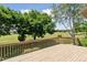Lovely backyard deck overlooking a golf course and several mature shade trees on a bright and sunny day at 1123 Oakhurst Dr, Broomfield, CO 80020