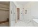 Modern bathroom showcasing a large walk-in shower with a rainfall showerhead and white marble tiling at 1123 Oakhurst Dr, Broomfield, CO 80020