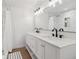 Elegant bathroom featuring double vanity, modern fixtures, and a spacious glass-enclosed shower at 1123 Oakhurst Dr, Broomfield, CO 80020