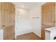 Bright bathroom with wood-look floors, a shower over tub, and two doors at 1123 Oakhurst Dr, Broomfield, CO 80020