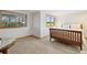 Comfortable bedroom with a classic bed frame and windows offering pleasant views of the outdoors at 1123 Oakhurst Dr, Broomfield, CO 80020
