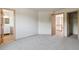 Spacious bedroom featuring neutral carpet, paint, and an open doorway to the rest of the house at 1123 Oakhurst Dr, Broomfield, CO 80020