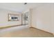 Clean bedroom with mirrored closet doors, carpet flooring, and a window view at 1123 Oakhurst Dr, Broomfield, CO 80020