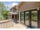 Large wooden deck features multiple access points to the home, ideal for outdoor entertaining at 1123 Oakhurst Dr, Broomfield, CO 80020