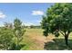 View of a well-manicured golf course from a residential property, complete with lush greenery and scattered trees at 1123 Oakhurst Dr, Broomfield, CO 80020