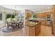 Open kitchen and breakfast nook with chandelier and scenic views at 1123 Oakhurst Dr, Broomfield, CO 80020