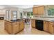 Open kitchen layout with island cooktop and adjacent breakfast area at 1123 Oakhurst Dr, Broomfield, CO 80020
