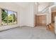 Spacious living room with large windows, and staircase access to upper level, offering natural light and airy feel at 1123 Oakhurst Dr, Broomfield, CO 80020