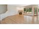 Cozy living room with hardwood floors, fireplace, and large windows, perfect for relaxation at 1123 Oakhurst Dr, Broomfield, CO 80020