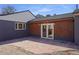 Backyard featuring a stone patio with a home exterior that has wooden sidings at 5730 E 19Th Ave, Denver, CO 80220