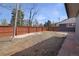 Large backyard with a wooden fence, offering privacy and space for outdoor activities at 5730 E 19Th Ave, Denver, CO 80220