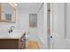 Bright bathroom features updated vanity, modern fixtures, and shower with vertical white tiling at 5730 E 19Th Ave, Denver, CO 80220