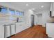 Bright kitchen with white cabinetry, modern stainless appliances, and stylish backsplash at 5730 E 19Th Ave, Denver, CO 80220