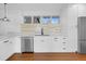 Clean kitchen featuring white cabinetry, stainless steel appliances and modern backsplash at 5730 E 19Th Ave, Denver, CO 80220