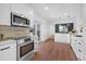 Modern kitchen with stainless steel appliances, white cabinets, and a bright and airy design at 5730 E 19Th Ave, Denver, CO 80220
