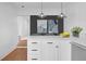 Close up of a bright kitchen featuring white cabinets, quartz countertops, and stainless steel appliances at 5730 E 19Th Ave, Denver, CO 80220