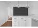Modern kitchen with stainless steel appliances, white cabinetry, and dining area at 5730 E 19Th Ave, Denver, CO 80220