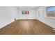 Bright living room featuring hardwood flooring and natural light from large windows at 5730 E 19Th Ave, Denver, CO 80220