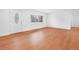 Bright living room featuring wood floors, a bay window and a white front door at 5730 E 19Th Ave, Denver, CO 80220