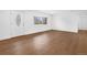 Bright living room featuring hardwood flooring and natural light from large windows at 5730 E 19Th Ave, Denver, CO 80220