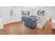 Sunlit living room showcasing a stylish couch, modern decor, and shiny hardwood flooring at 5730 E 19Th Ave, Denver, CO 80220