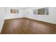 Bright living room featuring hardwood flooring and natural light from large windows at 5730 E 19Th Ave, Denver, CO 80220