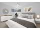 Serene main bedroom with a plush bed, stylish decor, and ample natural light from the corner windows at 5730 E 19Th Ave, Denver, CO 80220