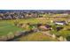 Aerial perspective featuring a home, expansive lawn, mature trees, and a community setting at 5800 W Bowles Ave, Littleton, CO 80123
