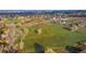 Expansive aerial view showcasing lush green fields interspersed with buildings in a residential area at 5800 W Bowles Ave, Littleton, CO 80123