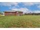 Brick house with a large green backyard on a sunny day, perfect for outdoor activities at 5800 W Bowles Ave, Littleton, CO 80123