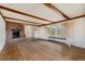 Bright living room with a brick fireplace, hardwood floors, and ample natural light, perfect for gatherings at 5800 W Bowles Ave, Littleton, CO 80123