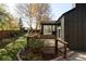 Spacious backyard featuring a deck, mature trees, and a well-manicured lawn at 4269 Carter Trl, Boulder, CO 80301