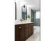 Stylish bathroom with dark wood cabinets, gold hardware, and a shower featuring green vertical tiles at 4269 Carter Trl, Boulder, CO 80301