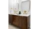 Modern bathroom vanity with double sinks, gold fixtures, and stylish wood cabinets at 4269 Carter Trl, Boulder, CO 80301