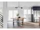 Bright dining area featuring a wood table, modern lighting, and large sliding doors to the outdoors at 4269 Carter Trl, Boulder, CO 80301