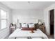 Bright bedroom featuring a plush bed, decorative pillows, and soft natural light from the window at 4269 Carter Trl, Boulder, CO 80301