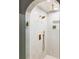 Modern tiled shower featuring an archway, rain shower head, and bronze fixtures at 4269 Carter Trl, Boulder, CO 80301