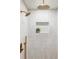 Modern shower with a rain shower head, built in shelf and neutral vertical tile at 4269 Carter Trl, Boulder, CO 80301