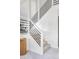 Modern staircase with white banister and black metal railings at 4269 Carter Trl, Boulder, CO 80301